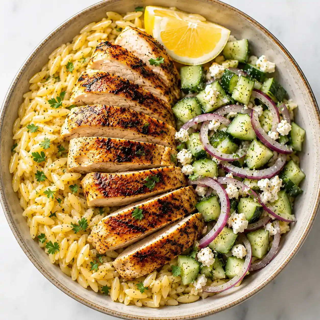 Grilled Chicken Orzo Salad recipe card featuring juicy grilled chicken, lemon herb orzo, cucumber, feta, and fresh vegetables